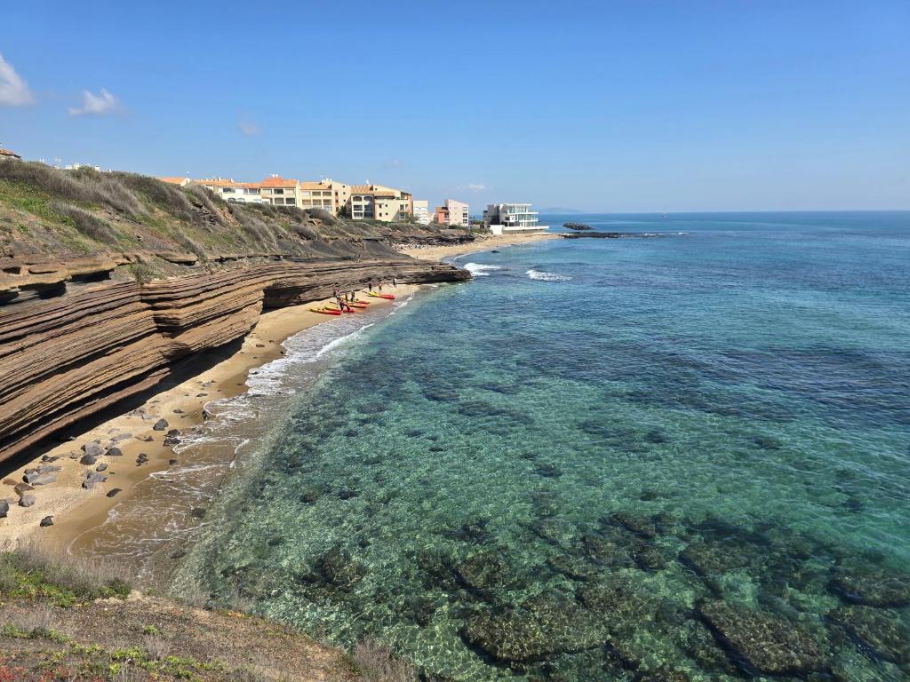 an aerial view of a beach with rocks and water at Love 2 avec Jacuzzi in Cap d'Agde