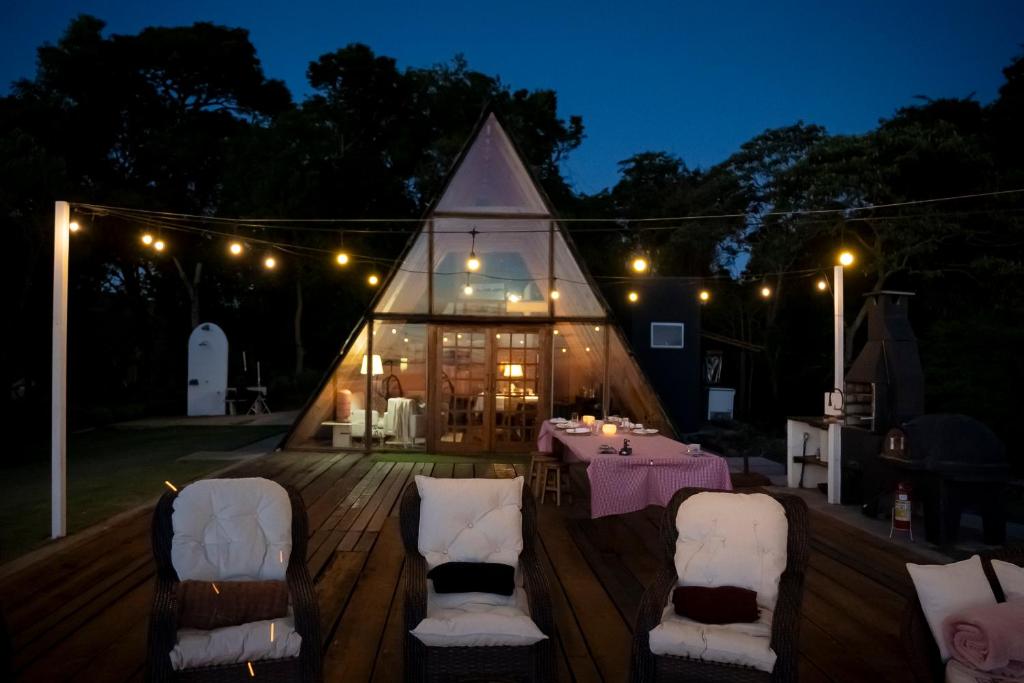 a marquee with a table and chairs in front of a building at Cabana Pico do Gavião in Andradas
