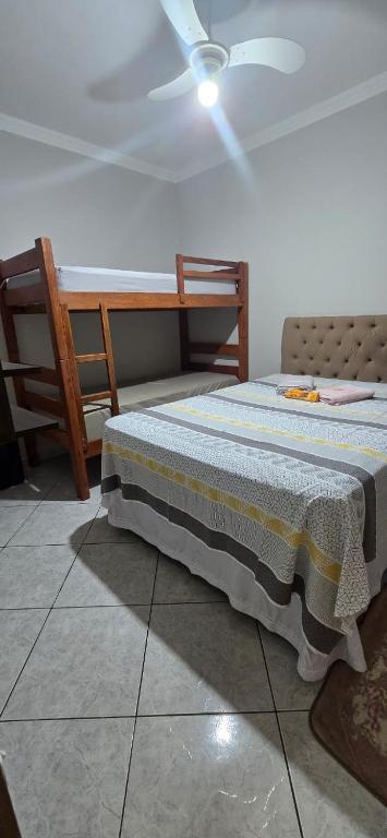 a bedroom with a bed and a ceiling fan at Villa Serena in Nova Odessa