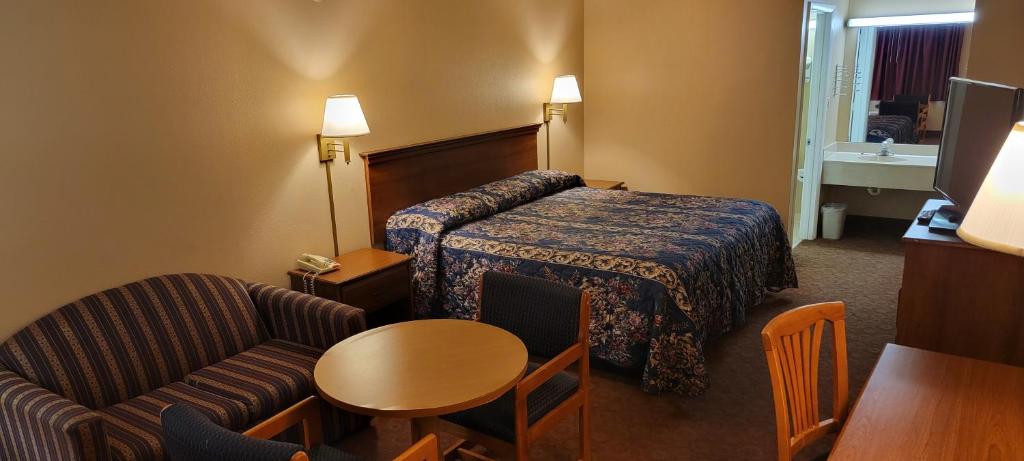 Ένα ή περισσότερα κρεβάτια σε δωμάτιο στο Budget Motel