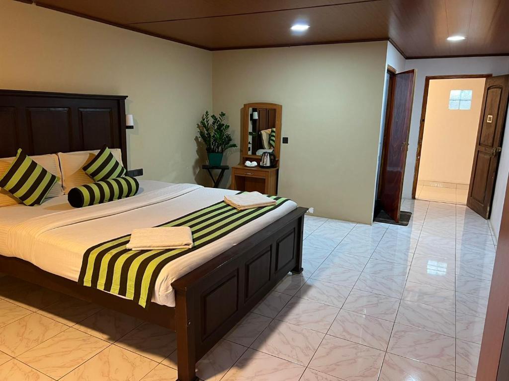 a bedroom with a large bed with striped pillows at Ella Berg Haven in Ella