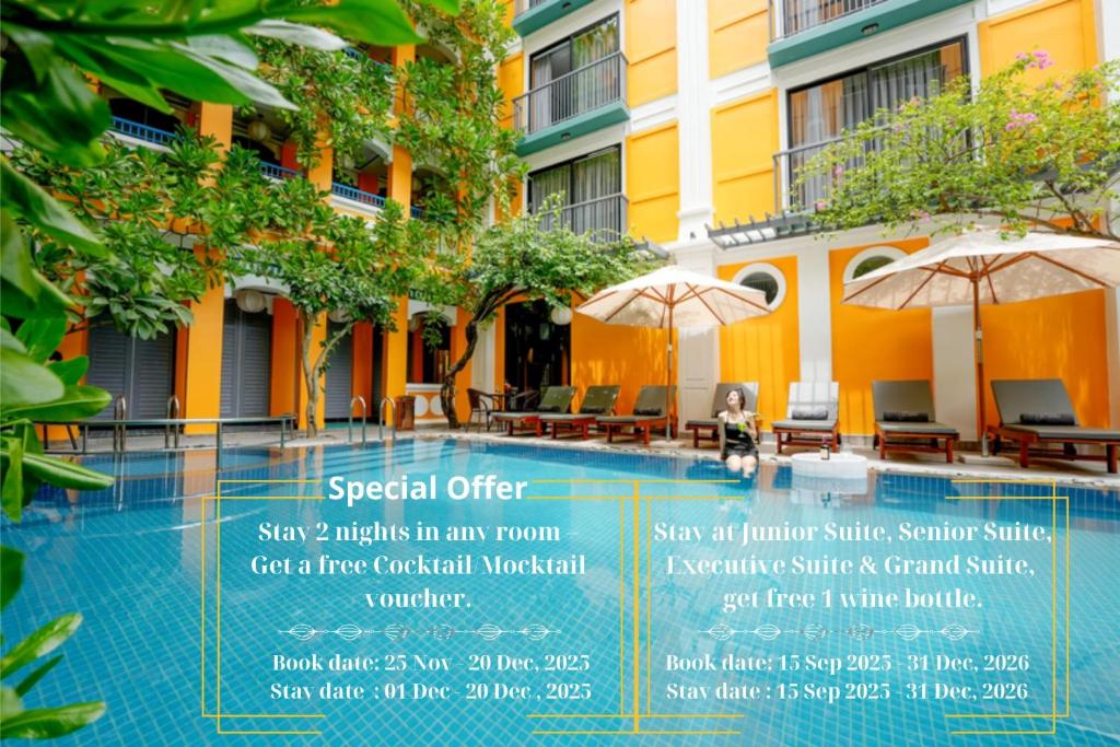 a sign next to a swimming pool in front of a building at Son Hoi An Boutique Hotel & Spa in Hoi An