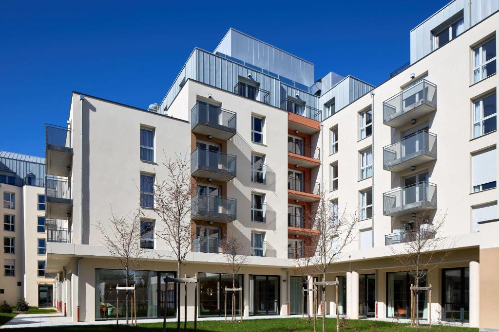 an apartment building with balconies on the side of it at Quality Suites Nancy Centre in Nancy
