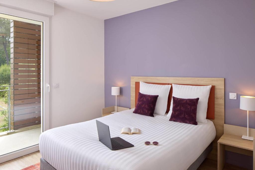 Una cama o camas en una habitación de Quality Suites Mont-de-Marsan