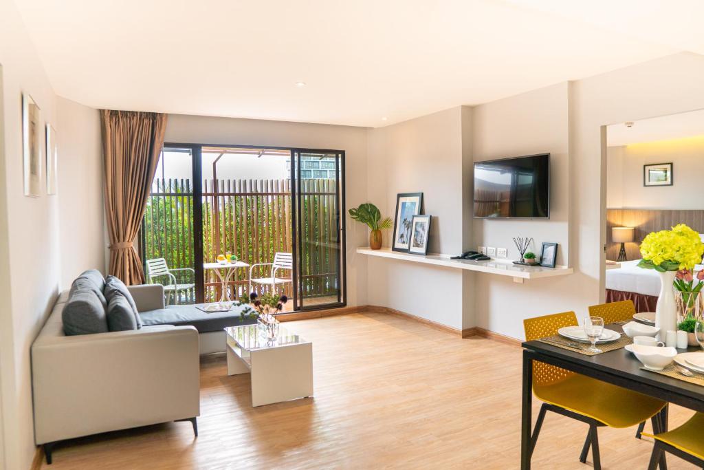 a living room with a couch and a table at Jazzotel Bangkok in Bangkok