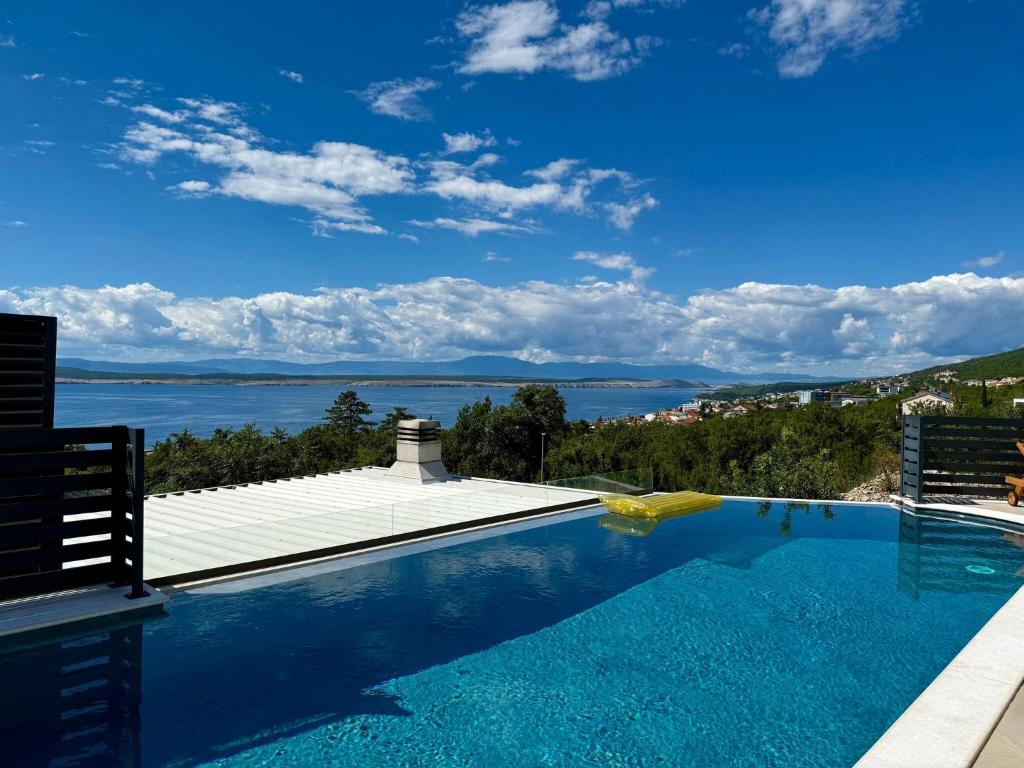 a swimming pool with a view of the water at Apartment in Croatia near the Adriatic Coast in Crikvenica