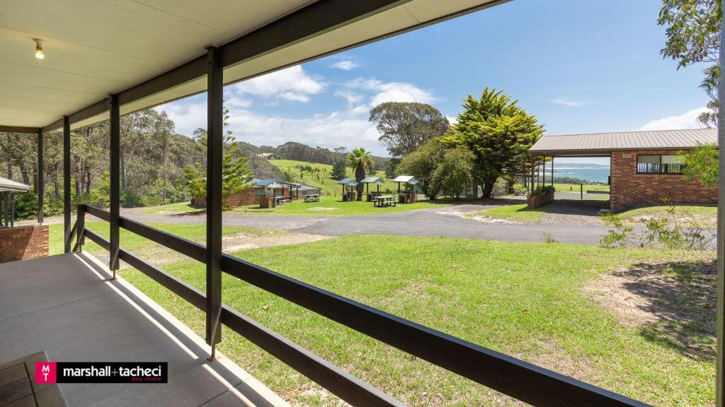 a view from the porch of a house at Cuttagee Beach Cottage 3 - Tathra Bermagui Rd 3521 in Barragga Bay