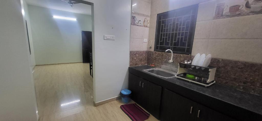 a bathroom with a sink and a mirror at Serene Steps Orion in Coimbatore