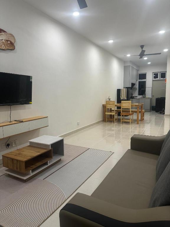 a living room with a couch and a flat screen tv at NHI Home Paka in Paka