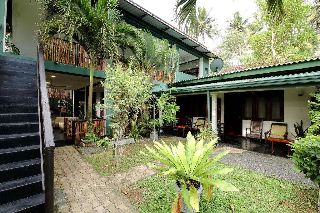 a house with a courtyard with a patio at Surf Dine in Matara