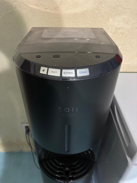 a black coffee maker sitting on top of a counter at This is OKINAWA in Motobu