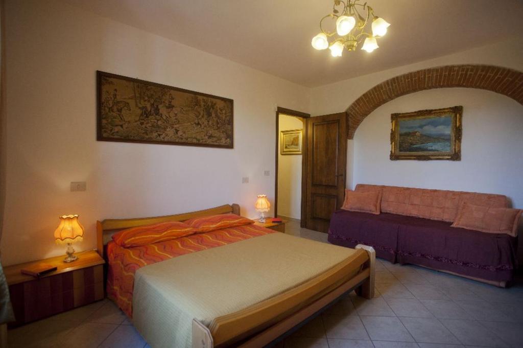 ein Schlafzimmer mit einem Bett und einem Sofa in der Unterkunft Alfieri Bed & Breakfast in Pisa