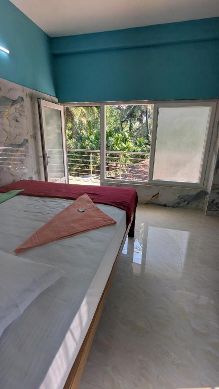 Postel nebo postele na pokoji v ubytování Nandish Guest House