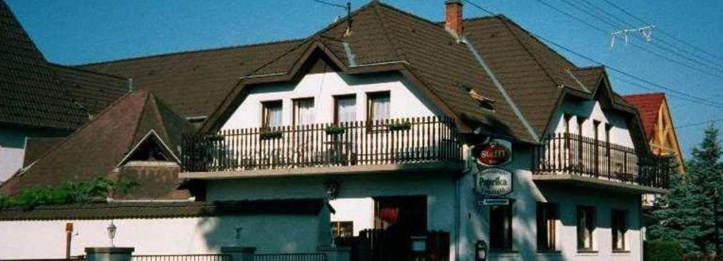 a large house with a balcony on top of it at Paprika vendégház in Harkány