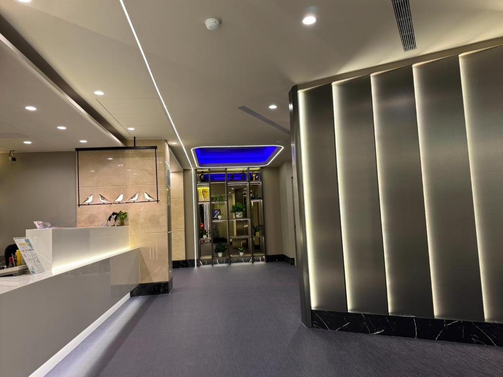 a restaurant lobby with a stainless steel wall at Forward Suites Ⅰ in Taipei