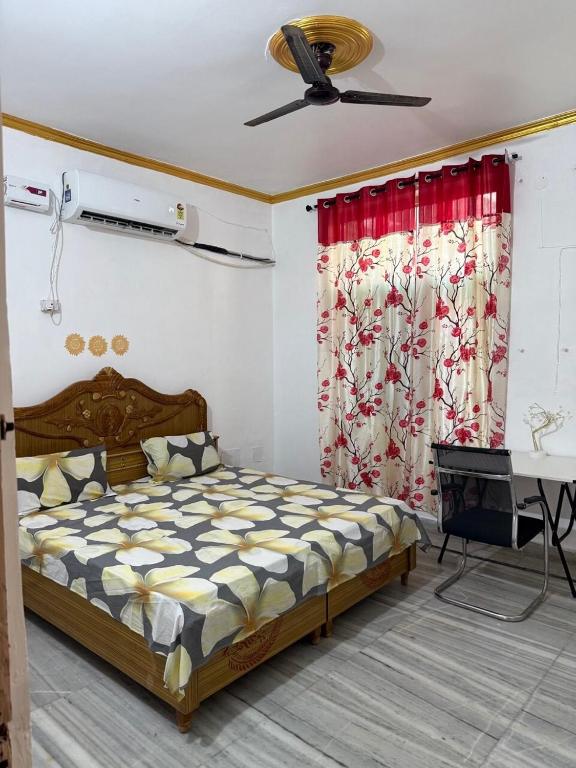 a bedroom with a bed and a ceiling fan at Pilgrim Abode Teerth Yatriyon ka Thikana in Jāmb