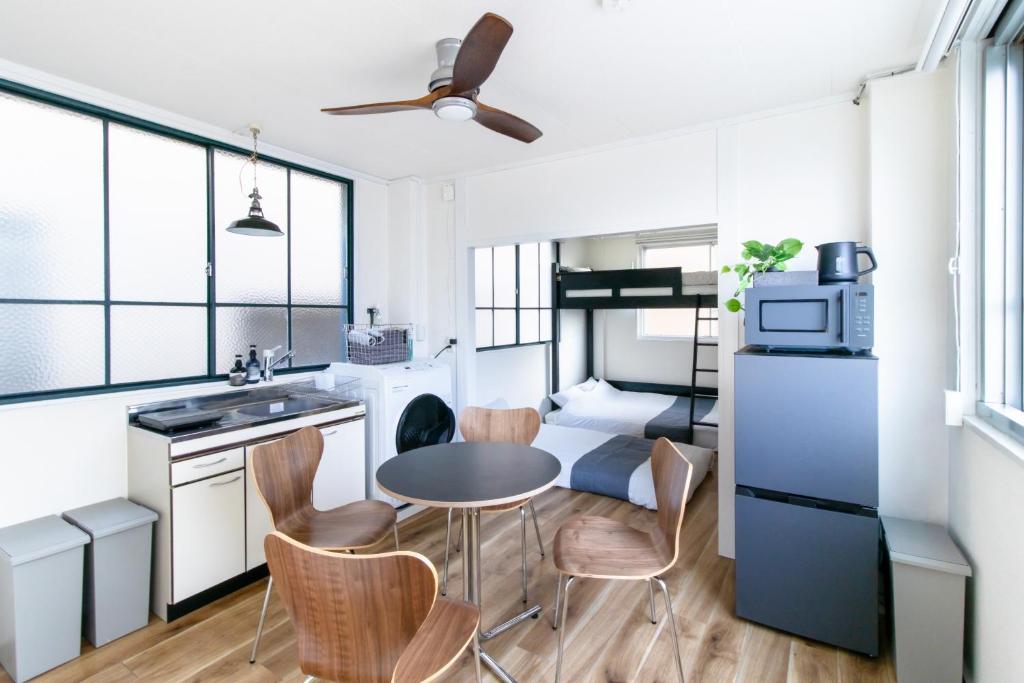 a small kitchen with a table and chairs in a room at epilogue hotel 302 in Fukuoka