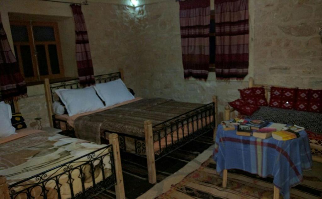 Postel nebo postele na pokoji v ubytování Kasbah Dar Talouste