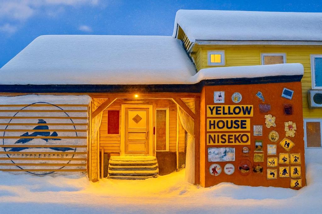 a model of a yellow house in the snow at Yellow House Niseko in Kutchan