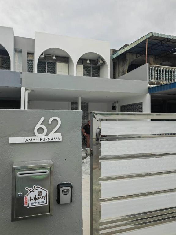 a building with a sign on the side of it at I-homey Residence 1 in Gua Sai