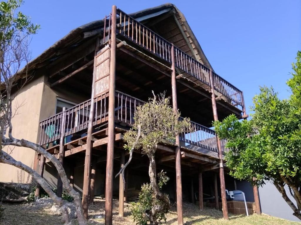 a house with a large deck on the side of it at Athule Inn - Mozambique in Chidenguele