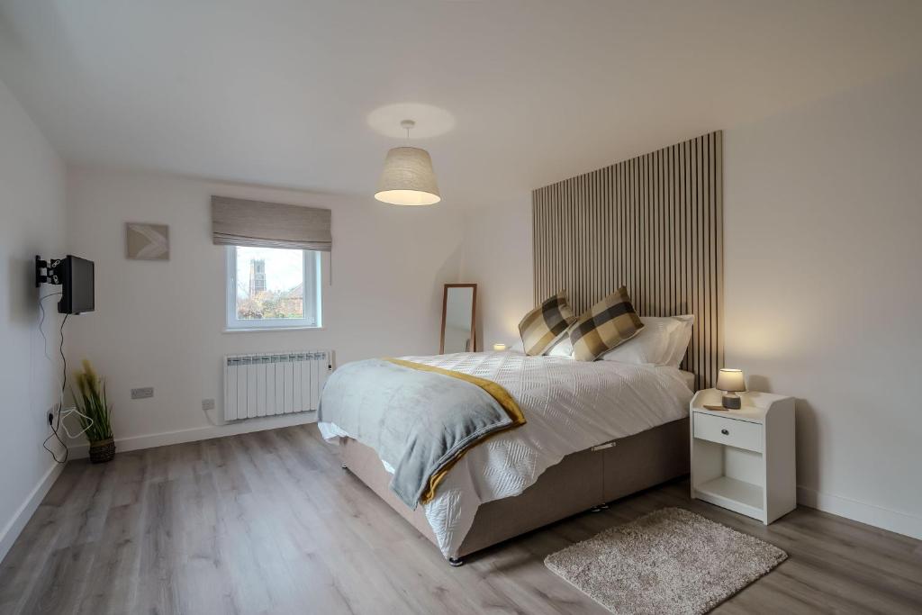 En eller flere senge i et værelse på Rothwill House by Winterton Cottages