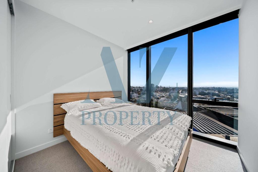a bedroom with a bed with a view of a city at Bright & Spacious 2BR in Prime CBD Location in Perth