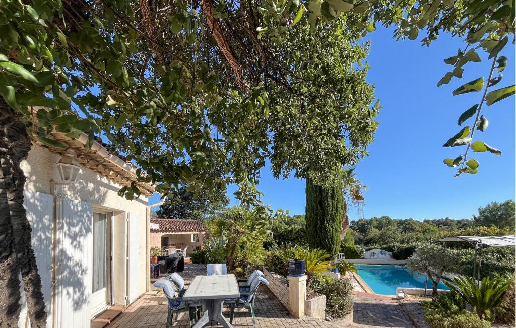 a patio with a table and chairs and a swimming pool at Villa Avec Piscine 1 in Roquebrune-sur-Argens