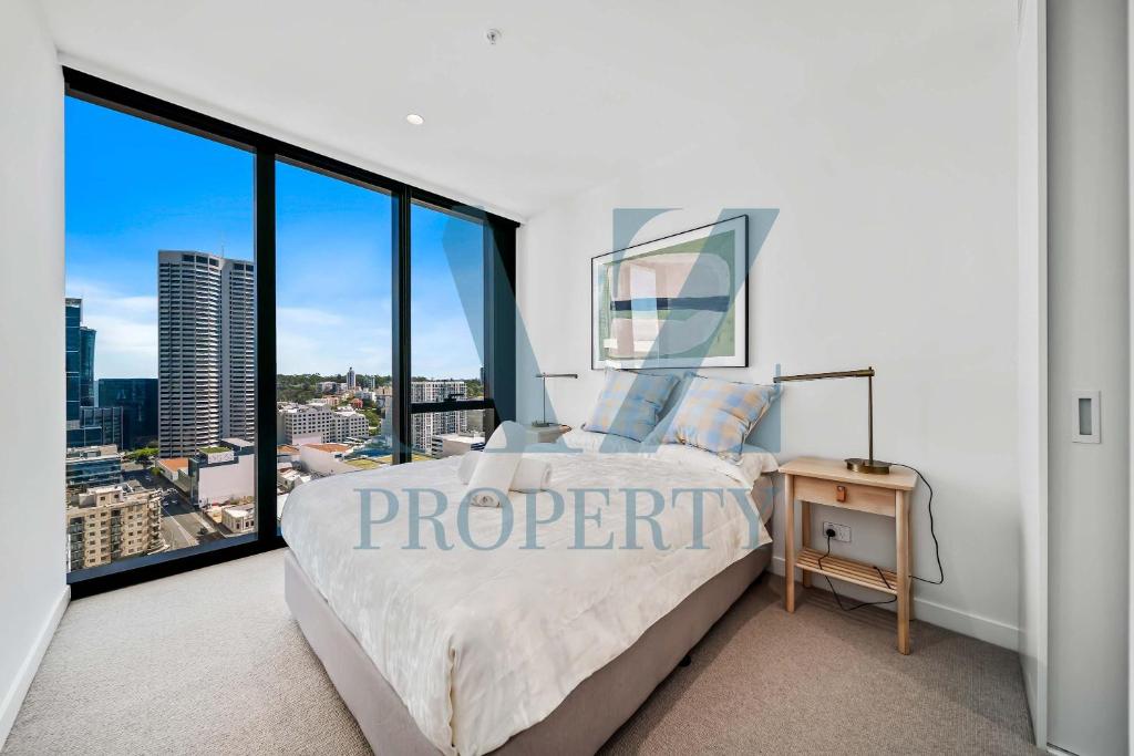a bedroom with a bed and a large window at Brand new Luxurious 2 Bedroom Perth CBD in Perth