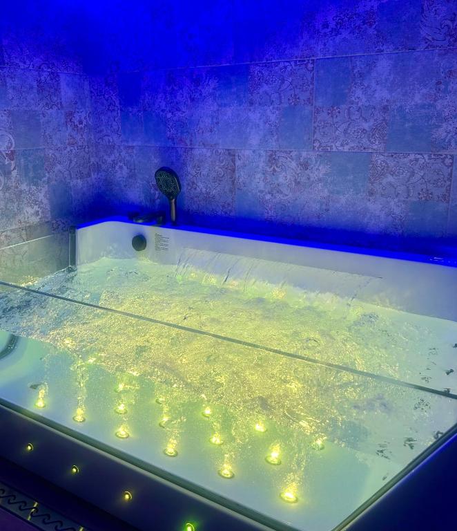 a bath tub with lights in a blue room at Vista Mare Apartments in Giardini Naxos