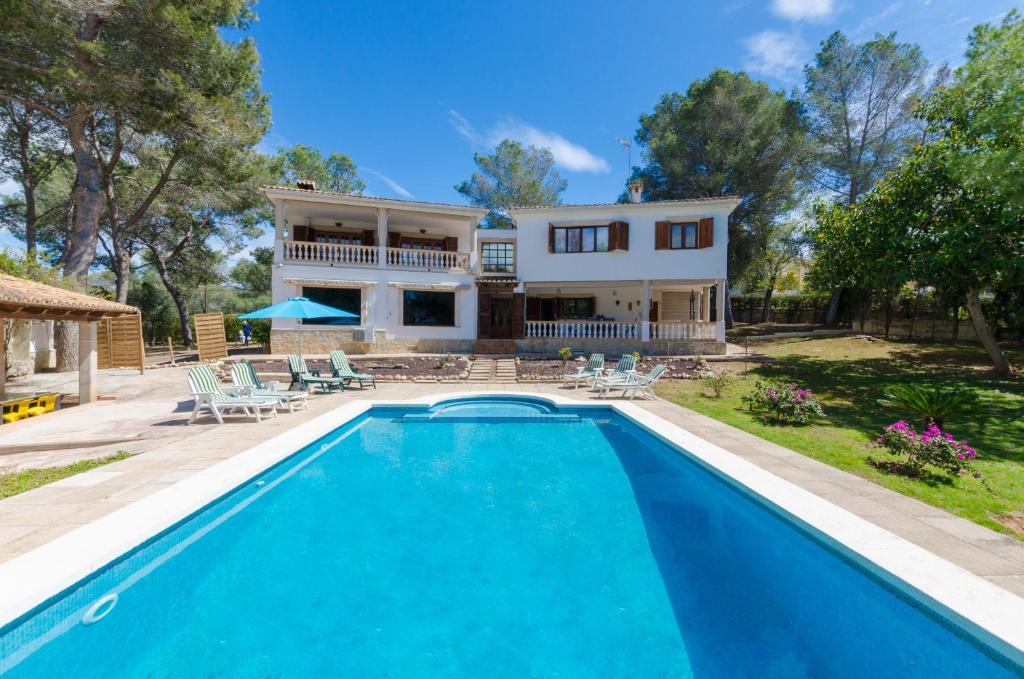 an exterior view of a house with a swimming pool at YourHouse Can Marques villa in Palma de Mallorca