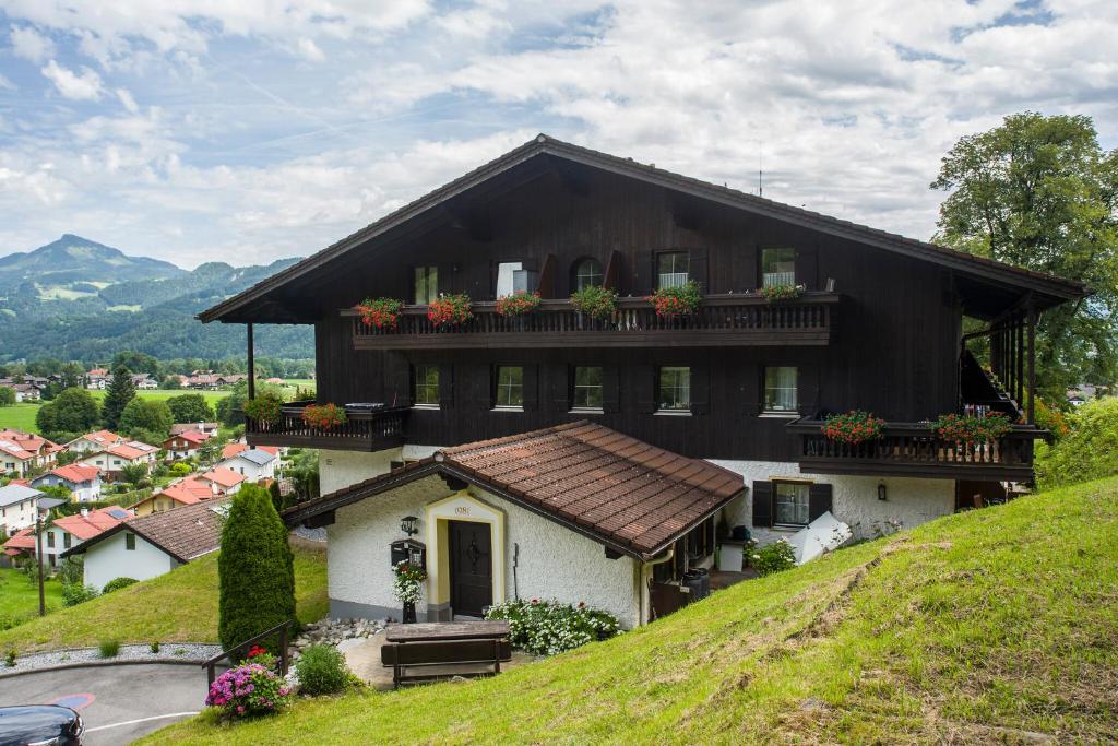 a house on a hill with flower boxes on it at FeWo "Bergidylle" im Bergschlößl in Oberaudorf