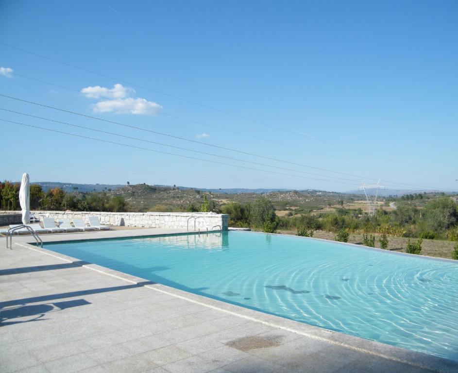 uma piscina com vista de uma casa em INATEL Vila Ruiva em Vila Ruiva