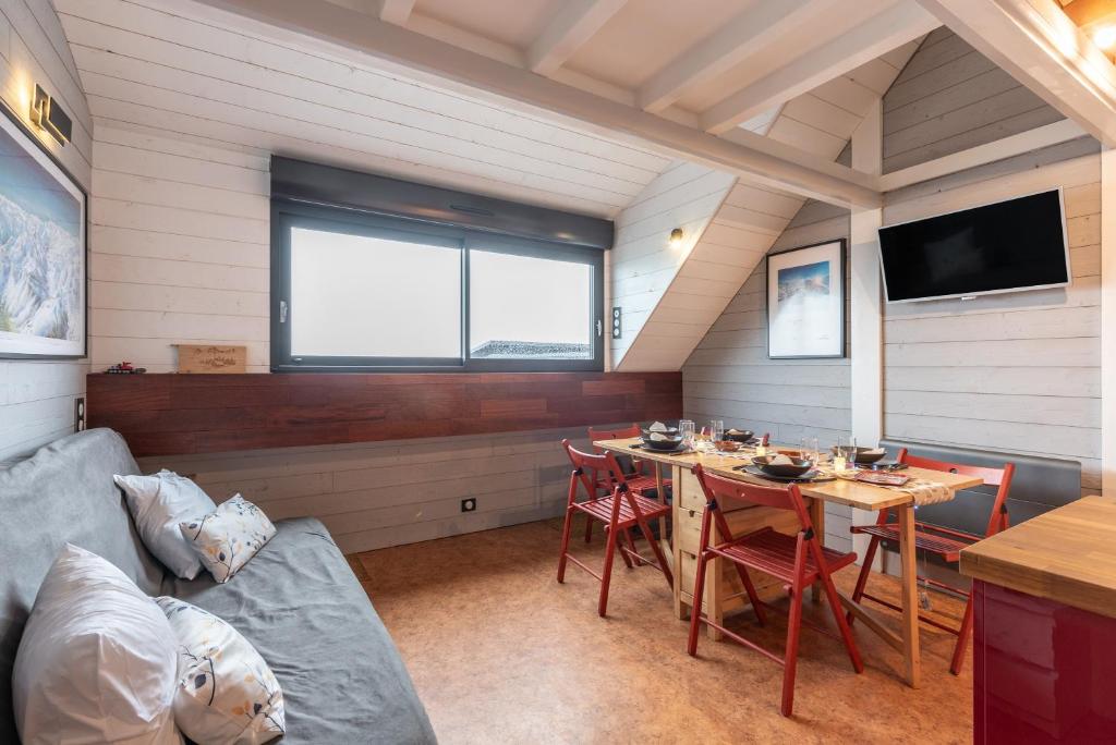 a living room with a table and a couch at Le Domaine du Lary in Saint-Lary-Soulan