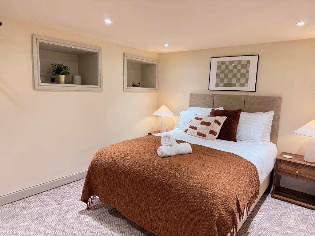 a bedroom with a bed with a teddy bear on it at The Meridian in Southport