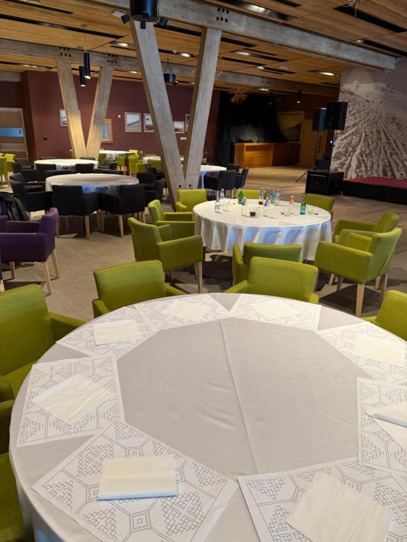 a dining room with white tables and green chairs at Apartman A 210 Aparthotel Vucko Jahorina private host in Jahorina