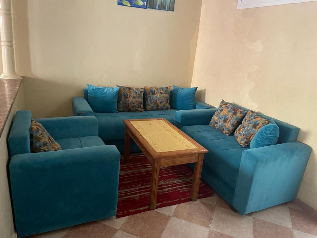 a living room with two blue couches and a table at Rest in Agadir