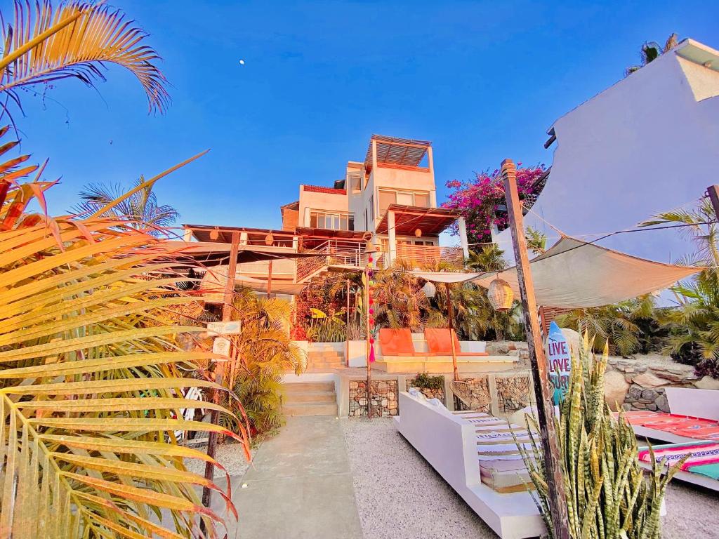 a house on the beach with an umbrella at Outsite Todos Santos - Formerly Perro Surfero Hotel Boutique in Todos Santos