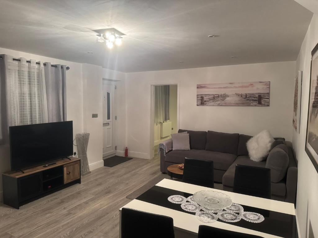 a living room with a couch and a tv at Dream Flat in Bristol