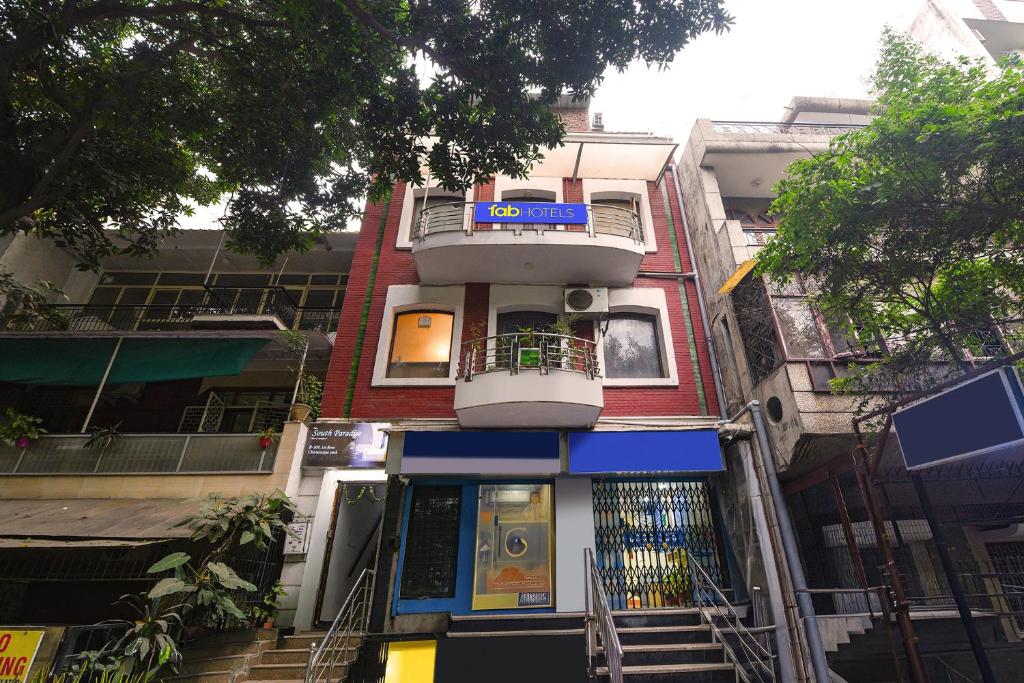 a building with a balcony on the side of it at FabHotel South Paradise in New Delhi
