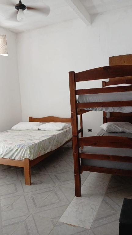 En eller flere senge i et værelse på Suítes Da Lady