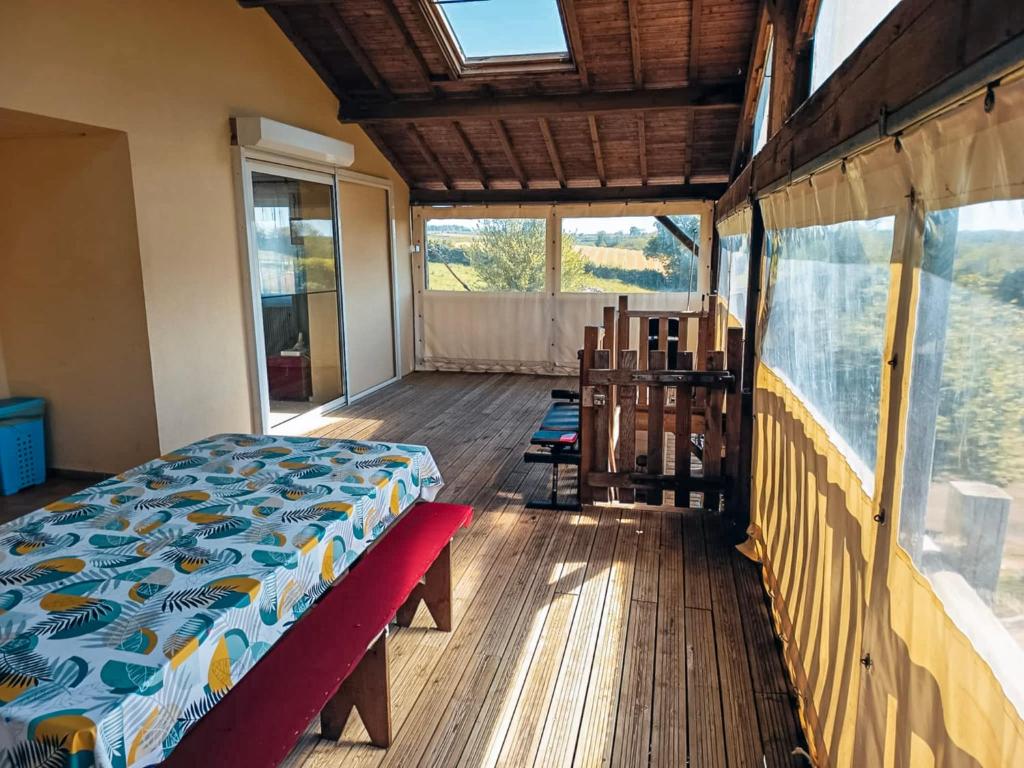 a bedroom with a bed on a wooden floor at Pavillon du Capitaine -25min Parc-By R&G in Montournais