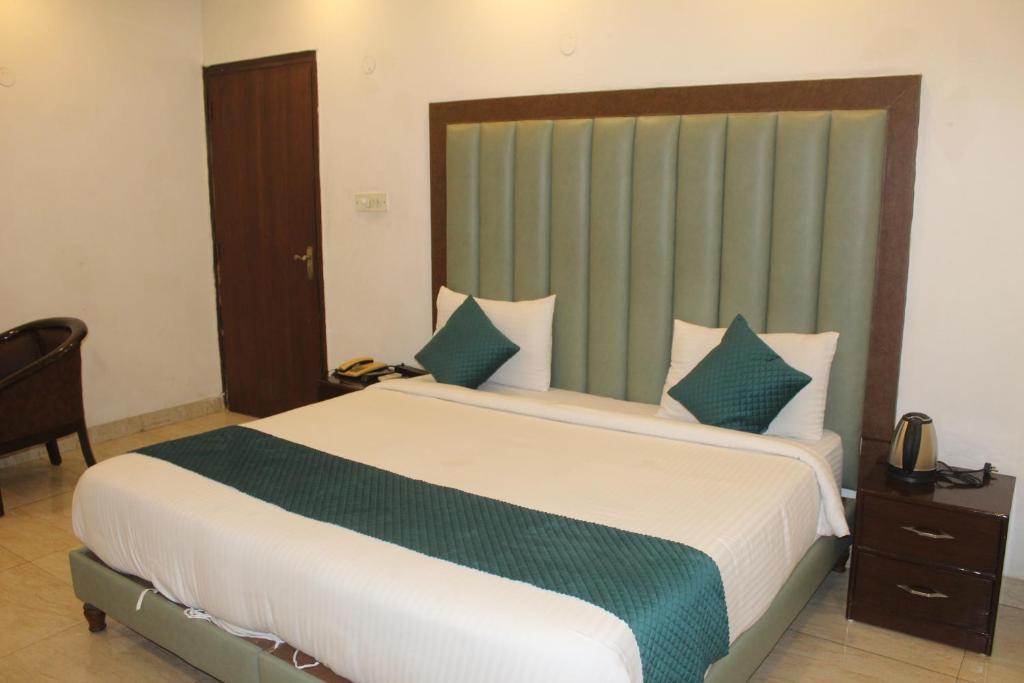 Ένα ή περισσότερα κρεβάτια σε δωμάτιο στο Khanna Residency