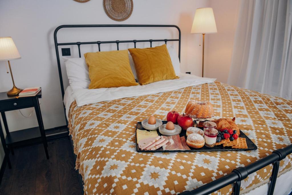 a tray of food on top of a bed at Open Concept Boutique Hotel - free breakfast & parking in Belgrade