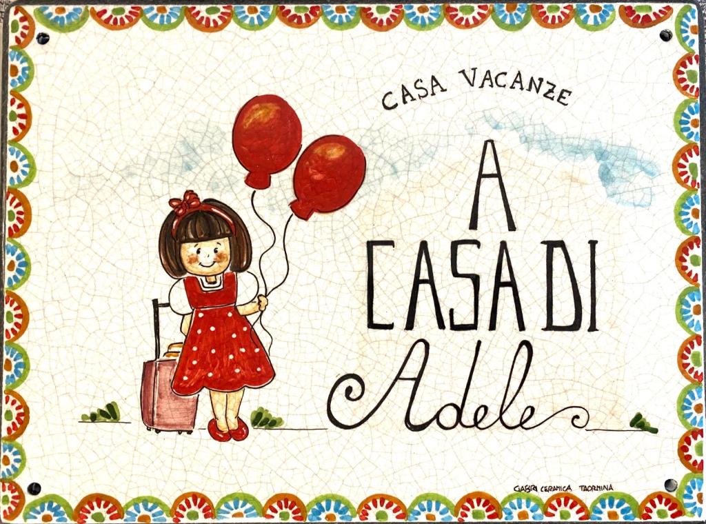 a book with a girl with balloons and a suitcase at A casa di Adele in Taormina