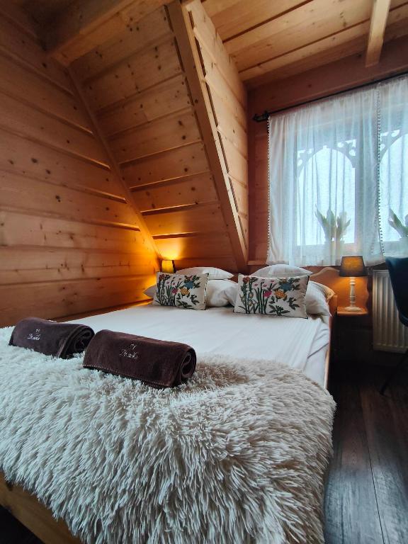 a bedroom with two beds in a log cabin at U Dziadka in Chochołów