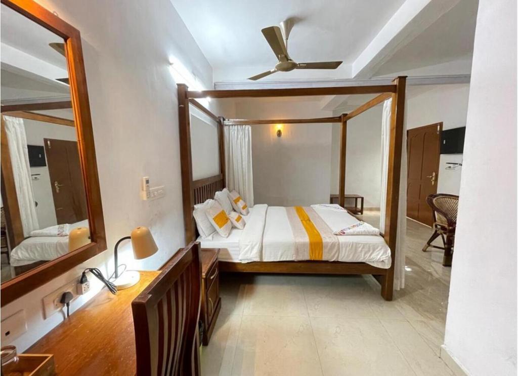 ein Schlafzimmer mit einem Bett und einem großen Spiegel in der Unterkunft The Boho Stays Kochi in Kochi