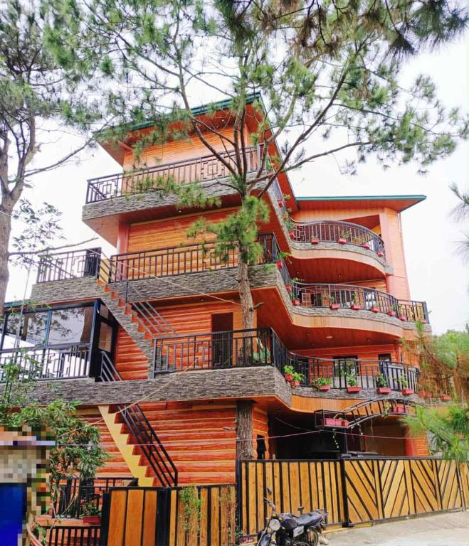 a building with balconies on the side of it at Forest Valley Homestay in La Trinidad