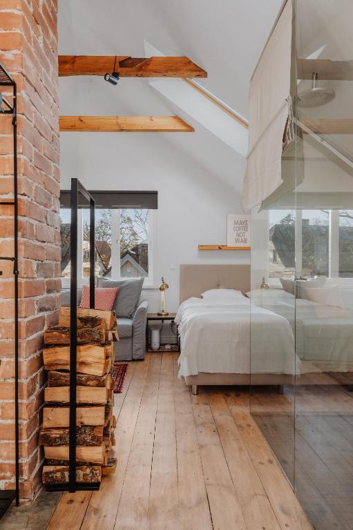 a bedroom with a bed and a brick wall at Haapsalu home by the sea in Haapsalu