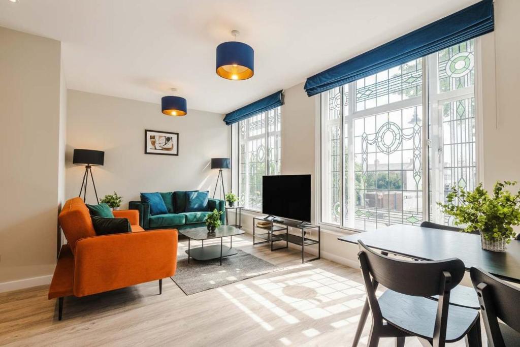 a living room with a couch and a table at Elysée Suites - Lovely 2 Bed Flat in Southport in Southport